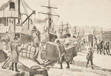 Hamnarbetare lastar varor vid Skeppsbron 1888